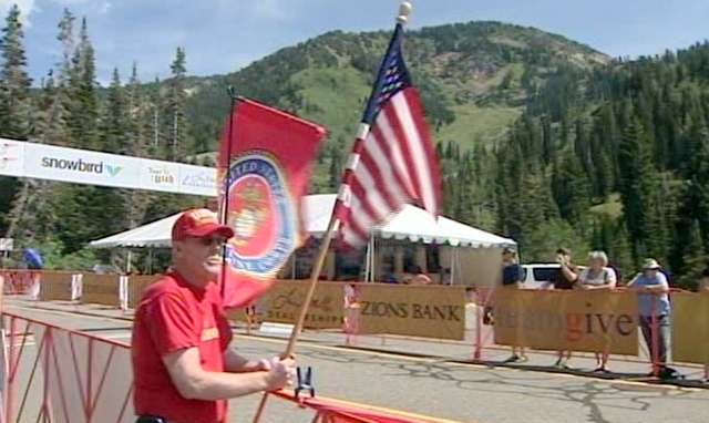A supporter of the wounded warriors waits along the track.
