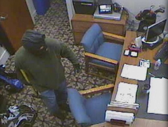 Surveillance video shows the burglar breaking into an office at South Mountain Golf Course Sunday.
