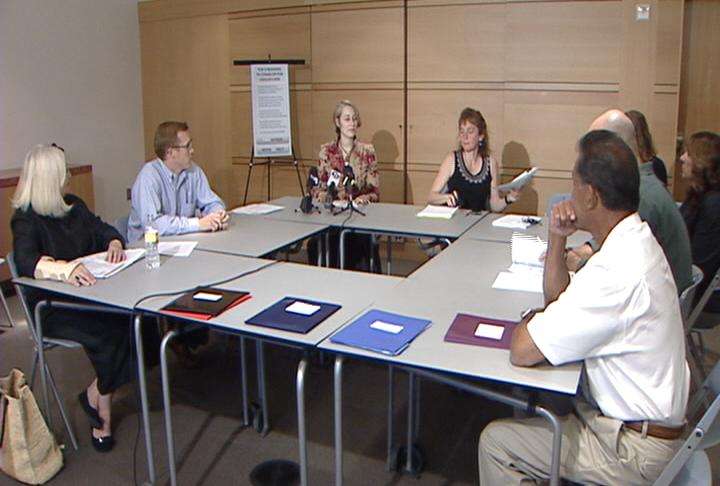 Group of people discuss health care reform at round table discussion Tuesday