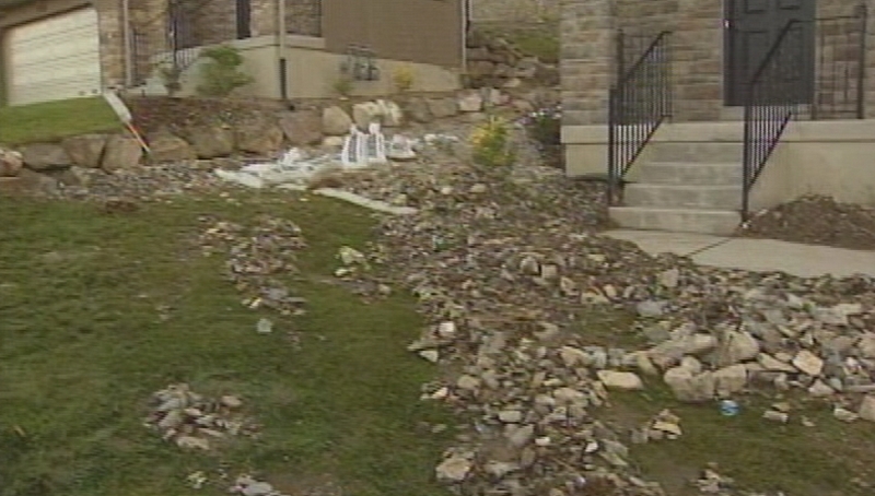 Neighborhood cleaning up after water tank floods the street