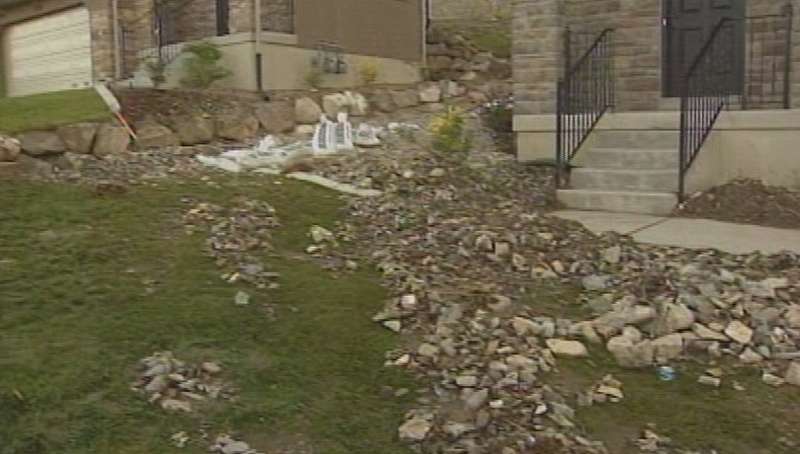 Neighborhood cleaning up after water tank floods the street