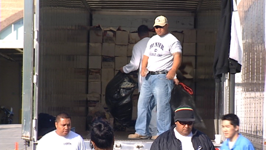Volunteers load donations into trucks that will transport them to the West Coast. The donated items will then be flown to the Samoan islands.