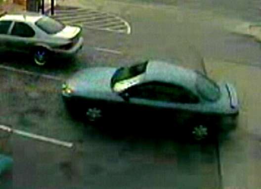 The robber's getaway vehicle, a green Dodge Neon, was caught on surveillance video as he left the parking lot.