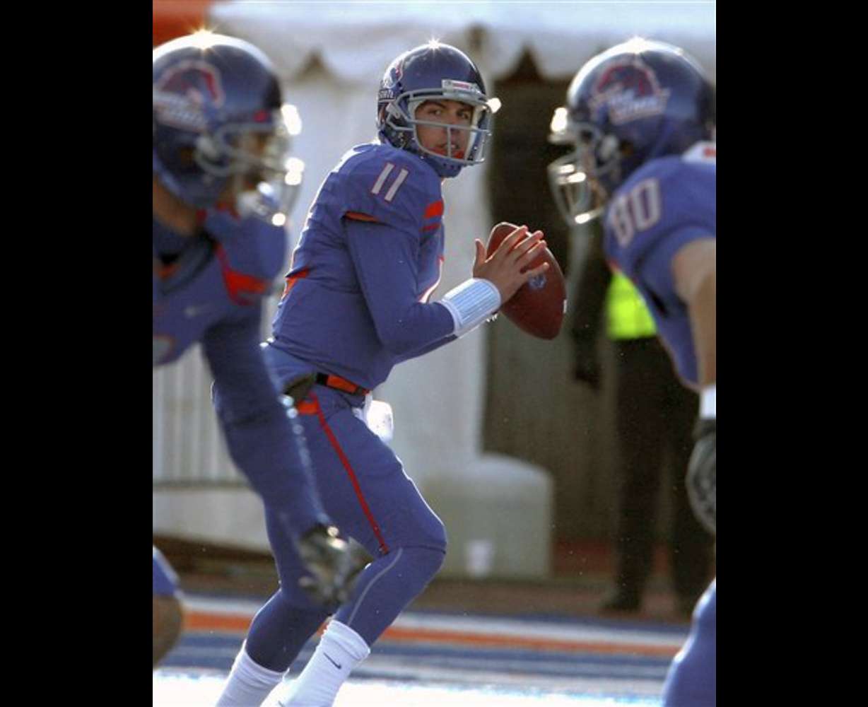 Boise State's Kellen Moore (11) looks downfield for a receiver during the first half against Idaho. (AP Photo/Matt Cilley)