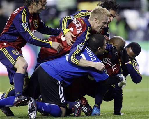 Real Salt Lake players mob Robbie Russell as they celebrate after Russell made a penalty kick to give Real Salt Lake a win over the Los Angeles Galaxy in the MLS Cup championship. (AP Photo/Ted S. Warren)