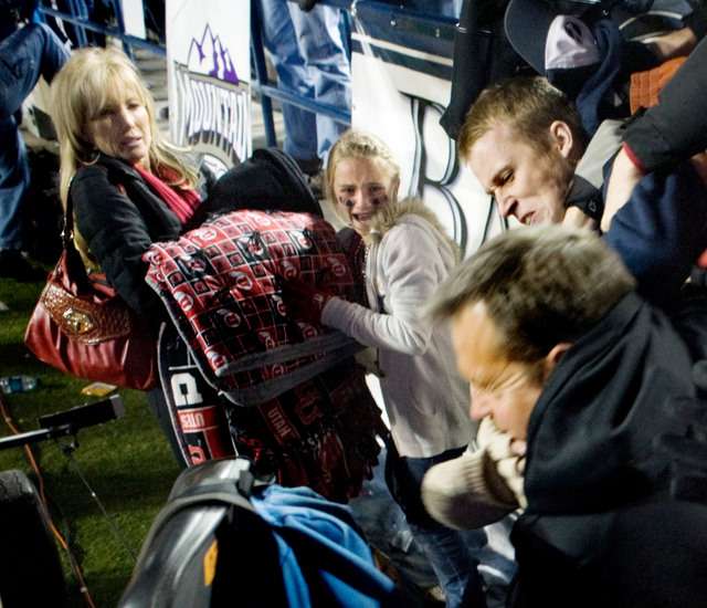 Jamie Whittingham and daughter Kylie watch as BYU Cougars and Utah Utes fans tangle after BYU's 26-23 overtime victory at LaVell Edwards Stadium. Whittingham is the wife of Utah coach Kyle Whittingham (not pictured). Courtesy Douglas C. Pizac-US PRESSWIRE