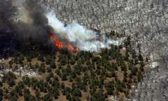 The Milford Flat fire burns around I-15 near the I-80 interchange, seen in this aerial view Sunday afternoon. (AP Photo/The Salt Lake Tribune, Chris Detrick)