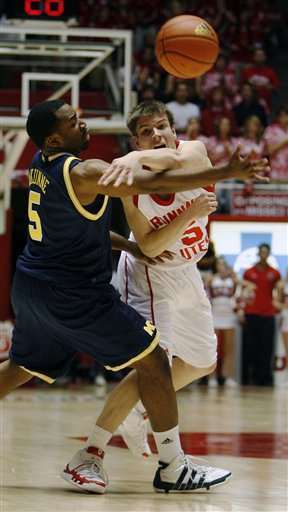 Utah guard Luka Drca (5), of Serbia, passes over the defense of Michigan guard Eso Akunne (5) during second half of an NCAA college basketball game in Salt Lake City, Wednesday Dec 9, 2009. (AP Photo/The Salt Lake Tribune, Steve Griffin)