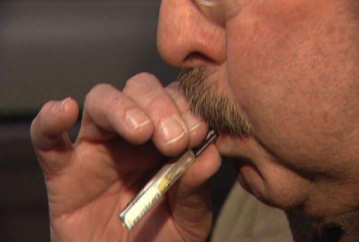 KSL's Keith McCord demonstrates how the personal Breathalyzer is used