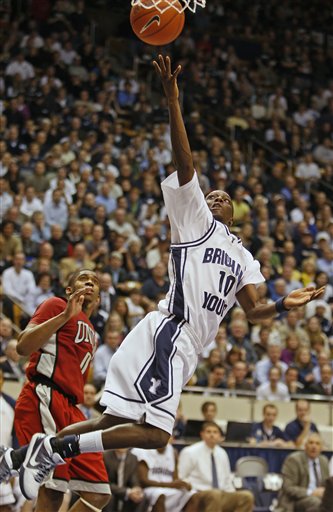 BYU's Michael Loyd, right, lays the ball in as UNLV's Oscar Bellfield looks on during the second half of an NCAA college basketball game in Provo, Utah, Wednesday, Jan. 6, 2010. BYU beat UNLV 77-73. (AP Photo/George Frey)