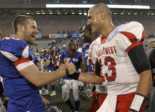 West quarterback Max Hall, left, of BYU, congratulates East quarterback Mike Kafka, of Northwestern, after the East West Shrine football game in Orlando, Fla., Saturday, Jan. 23, 2010. The East won 13-10. (AP Photo/Phelan M. Ebenhack)