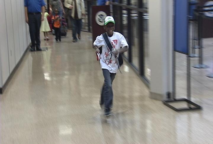 Young Fabrice Aitken dashed through the airport when he caught sight of his new grandparents and brothers and sister.