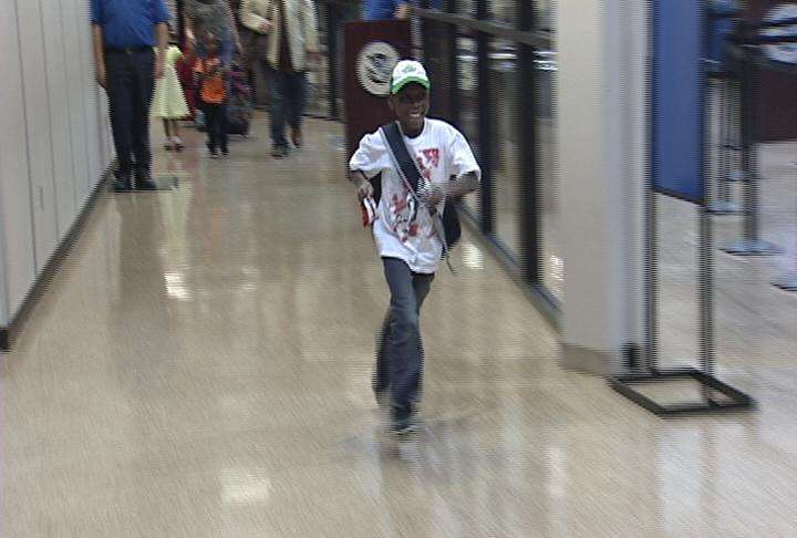 Young Fabrice Aitken dashed through the airport when he caught sight of his new grandparents and brothers and sister.