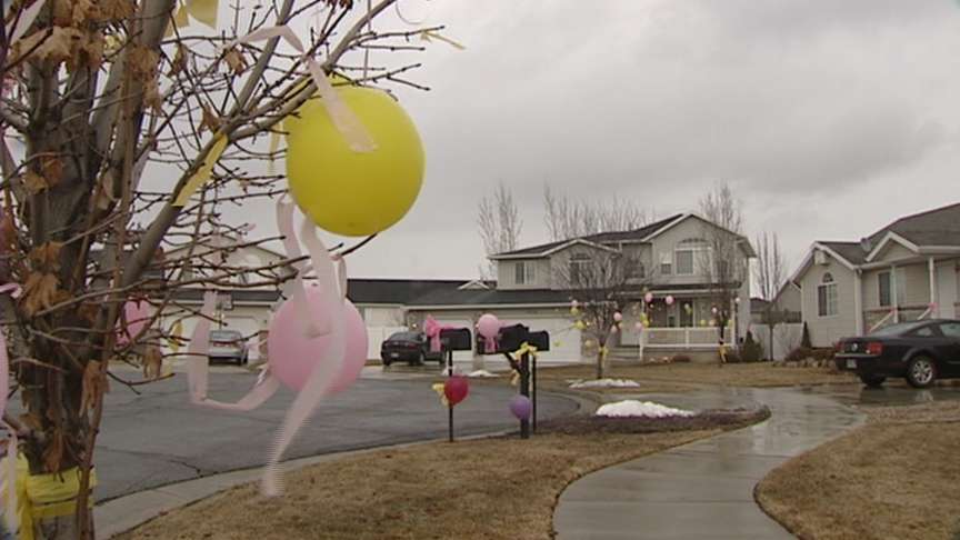 Neighbors hung balloons and ribbons in the girls' favorite colors to show love and support for the Toone family.
