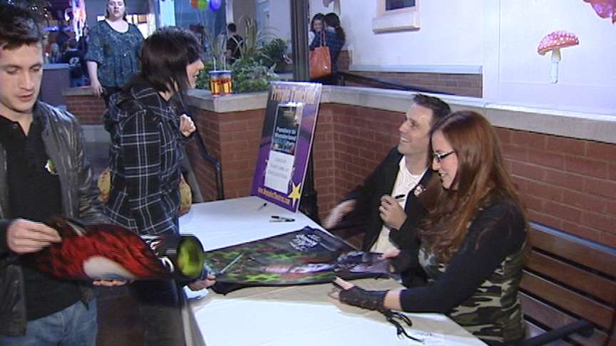 BYU graduate Seth Hippen signs autographs for fans at the Sandy premiere of "Alice in Wonderland."
