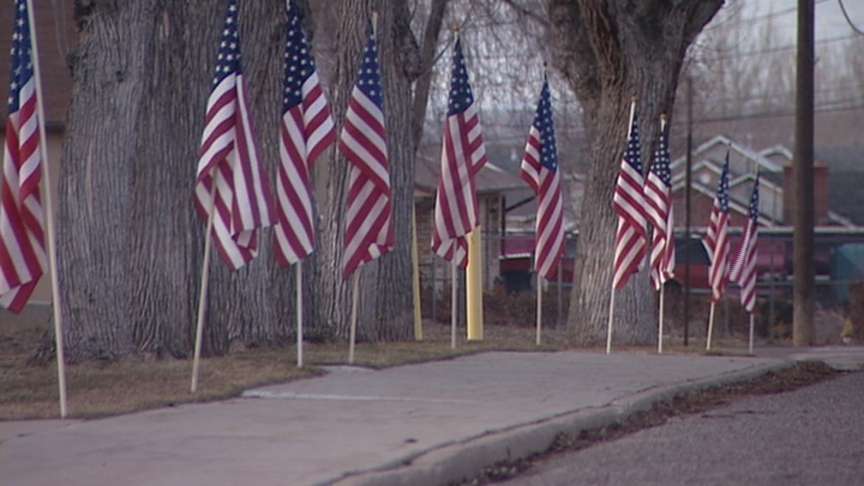 Flags line the Salem home of Olsen's family in his honor.