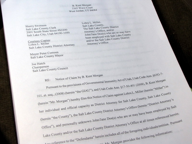 Kent Morgan filed a notice of claim with the county Wednesday, outlining his intent to sue to get his job back.