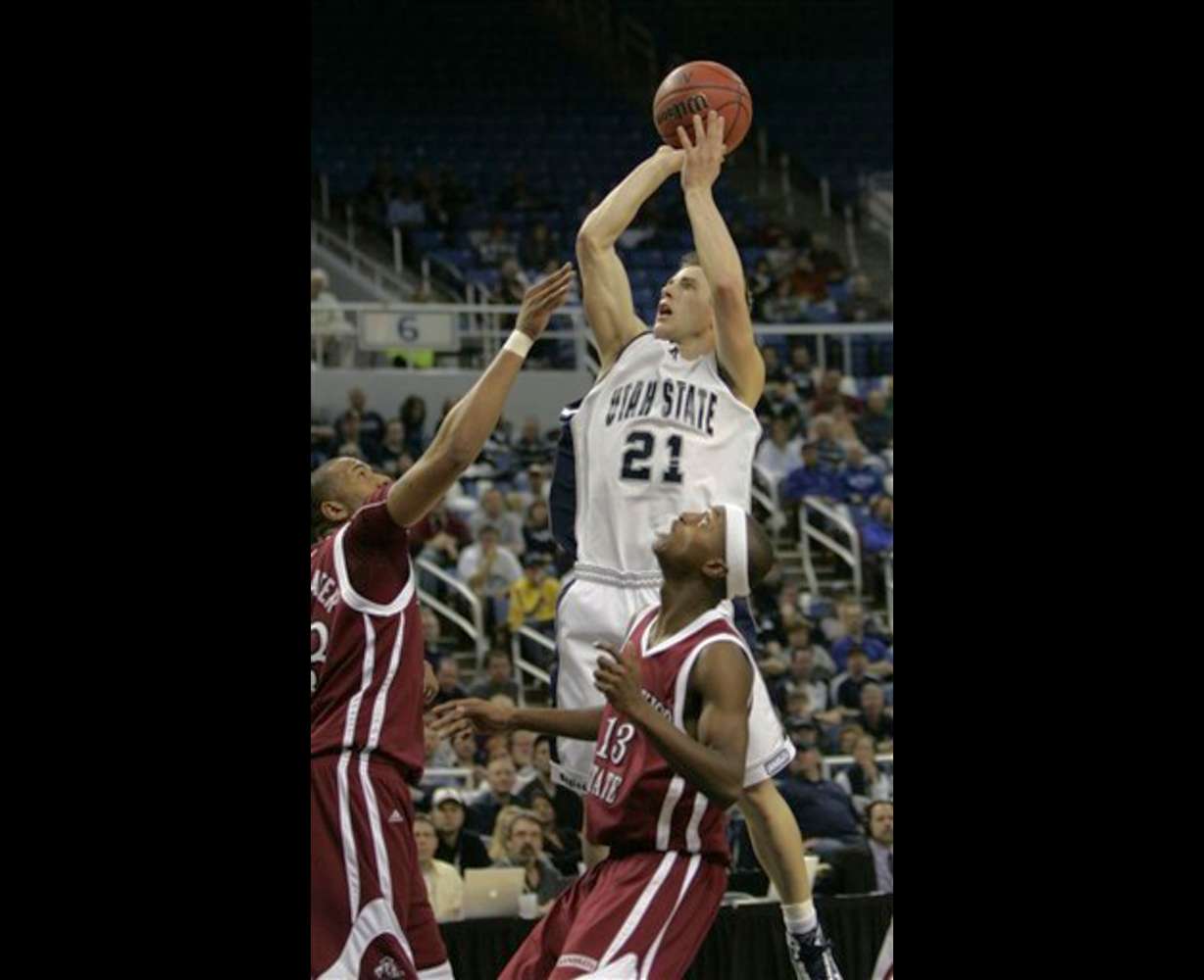 Utah State's Jared Quayle shoots over New Mexico State's Troy Gillenwater and Hernst Laroche during the WAC Championship. (AP Photo/Rich Pedroncelli)