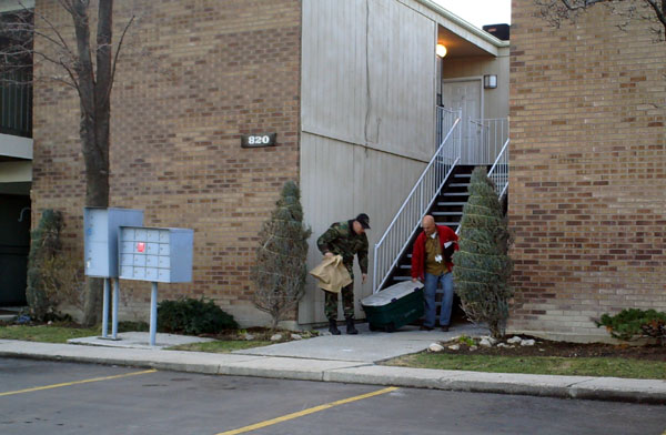 Police take evidence out of the condo where a man is accused of holding his girlfriend captive.