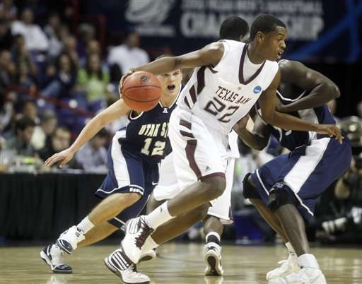 Texas A&M's Khris Middleton drives around Utah State's Brian Green, left, and Modou Niang. (AP Photo/Rajah Bose)