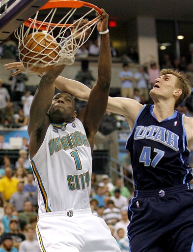 Utah Jazz forward Andrei Kirilenko (47), of Russia, tries block the dunk of New Orleans Hornets guard Kirk Snyder (1) during the second half of an NBA basketball game Friday, April 14, 2006, in Oklahoma City. Utah won 105-104. (AP Photo/Ty Russell)