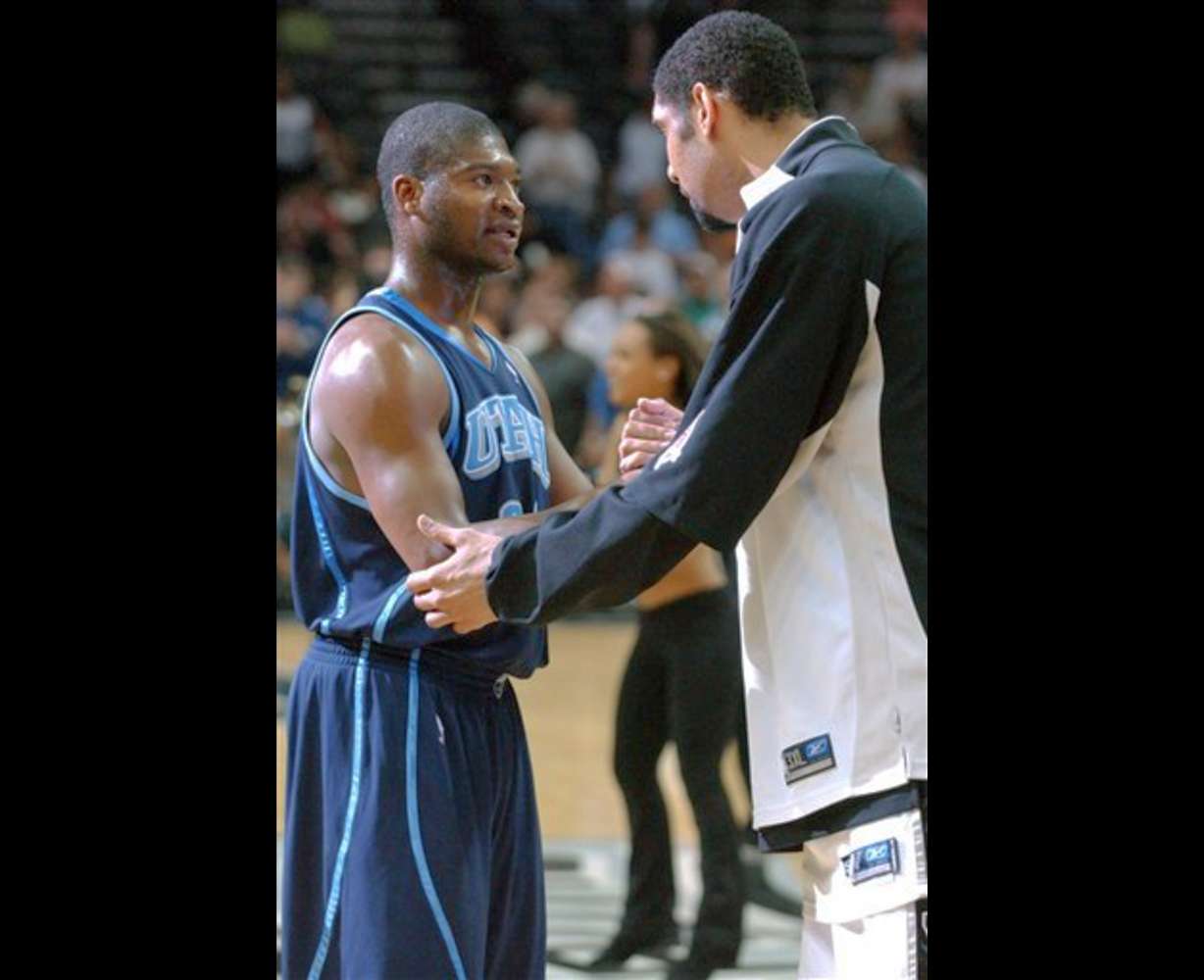 Utah Jazz's Devin Brown, left, talks with former teammate, San Antonio Spurs' Tim Duncan, after an NBA basketball game in San Antonio, Monday, April 17, 2006. The Spurs won 115-82. (AP Photo/Edward A. Ornelas)