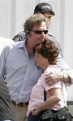 Colin King, left, a lawyer for several of the families of the trapped miners, hugs Nelda Erickson, right, the wife of trapped miner Don Ericson, outside the Desert Edge Christian Chapel before going inside for a briefing on efforts to locate the six miners trapped in the Crandall Canyon Mine on Sunday. (AP Photo/Kenny Crookston)