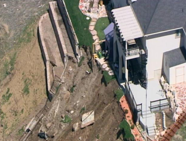 Man wants compensation for collapsed retaining wall