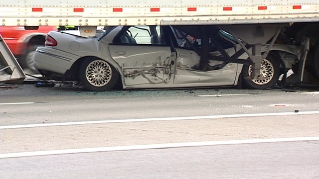 The crash sent a white car underneath a UPS truck. The driver had to be cut out, but he was not injured.