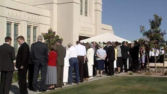 Members of The Church of Jesus Christ of Latter-day Saints enter the Gila Valley temple for dedicatory services