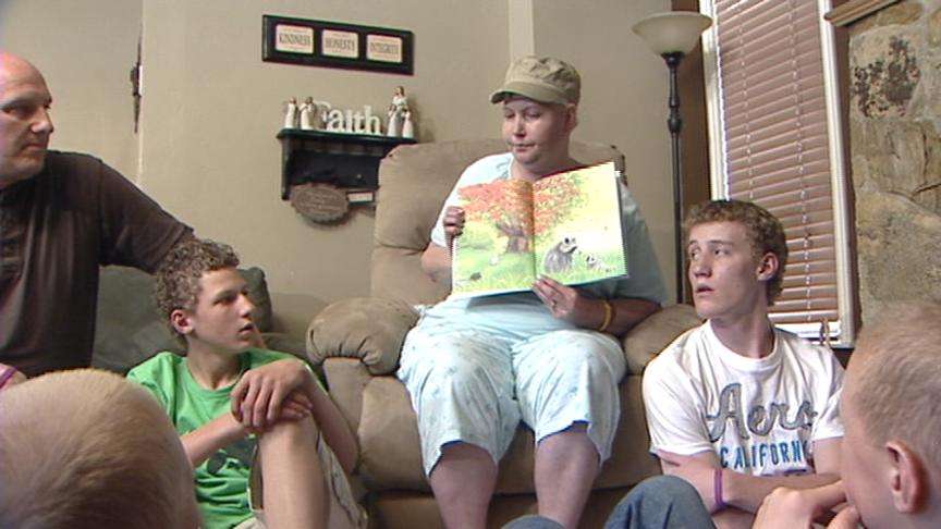 Amy Jackson reads one of her favorite books to her husband and five of her six children.