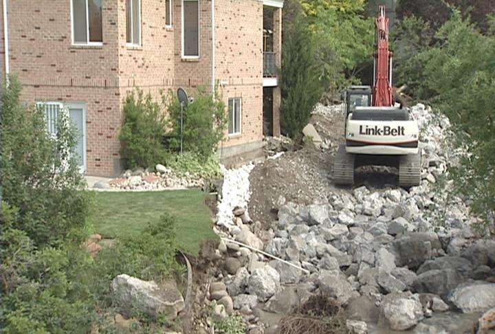 Kim World's yard is now full of boulders and debris following Monday's flood