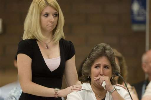 Tami Stewart, right, is comforted as she makes a statement during Ronnie Lee Gardner's commutation hearing. Stewart is the daughter of Nick Kirk, who was shot and seriously wounded by Gardner in 1985. (AP Photo/Trent Nelson, Pool)