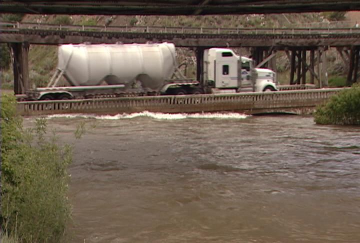 Rushing water of the Weber River is running high enough to touch the bottom of the Croydon bridge