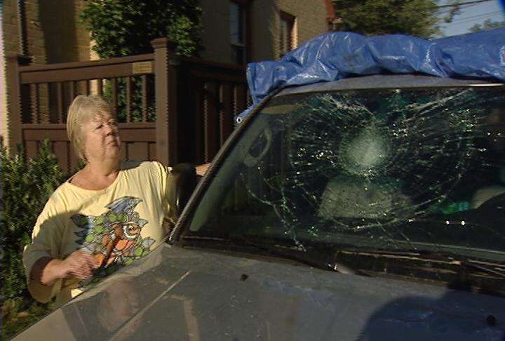 Pearl Simmons shows the damage done to her vehicle's windshield during an overnight vandalism spree.