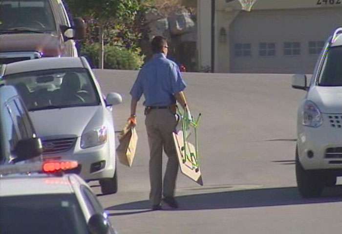 The collapsible table the child was trapped in is removed from the home following the incident.
