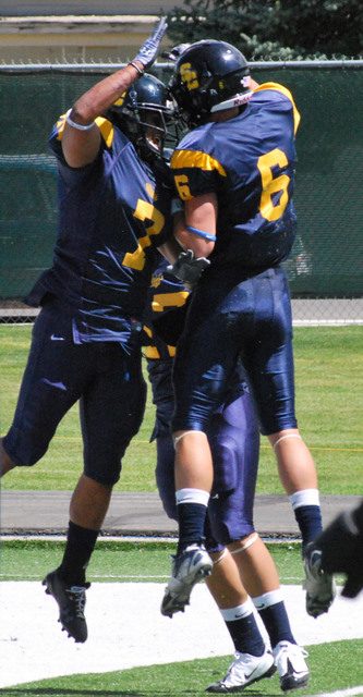 Runningback Muka Atiga (left) celebrates with receiver Tyler Rawlings after a first quarter touchdown during Snow College's
80-6 victory. (Tara Wayment, Snow College)