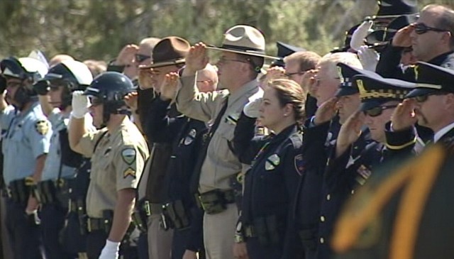 Law enforcement lined the road to follow Deputy Brian Harris to the cemetery.