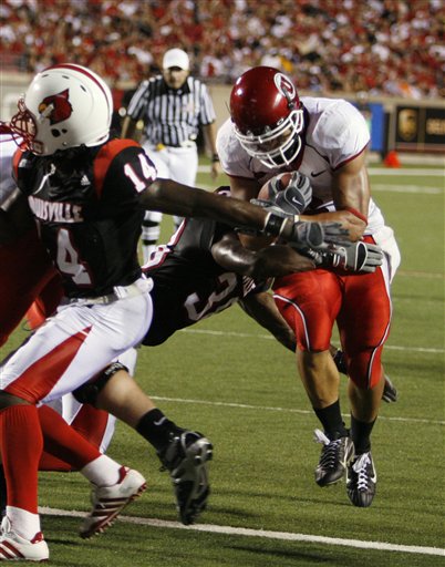 Johnson throws for 312 yards to help Utah hold off Louisville
