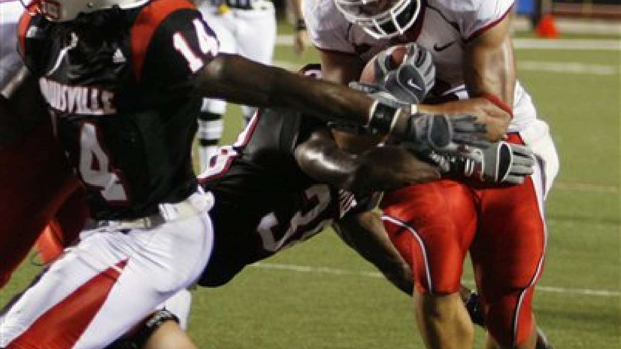 Johnson throws for 312 yards to help Utah hold off Louisville