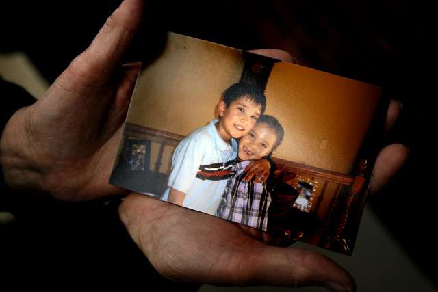 Kat, the next door neighbor, delicately holds a photo that she took of James and Jean Warhola in August. Kat said that James and Jean came over to her house frequently to chat. She described the children as "sweet little kids; well behaved, polite, happy and smiling" on September 9, 2010. (Photo/Laura Seitz)