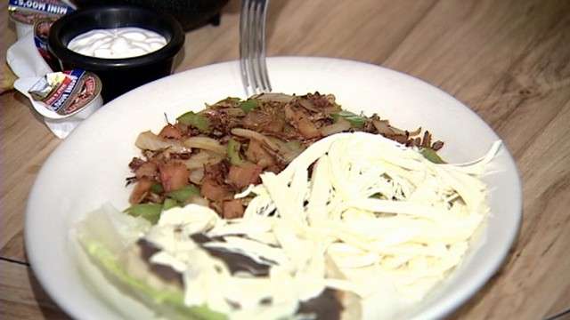 Traditional Mexican dish of fried onions, tomatoes, green bell peppers and grasshoppers.