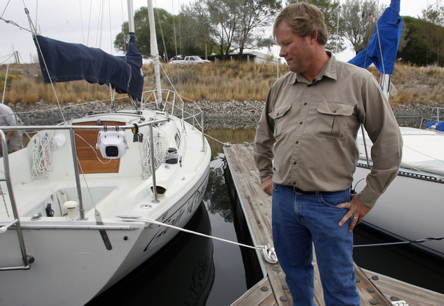 Tim Loveday looks at his boat, which he broke the rudder on yesterday due to low water levels in the Great Salt Lake, at the Great Salt Lake State Marina on Monday, October 11, 2010. (Kristin Murphy, Deseret News)