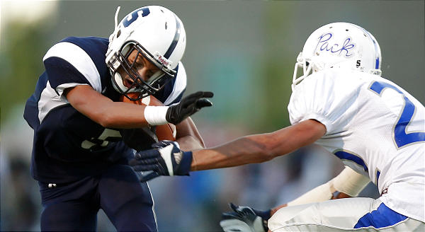 Syracuse's Shane Russell, left, tries to avoid a tackle by Fremont's Tyson Montgomery after making a catch. (Scott G. Winterton, Deseret News)