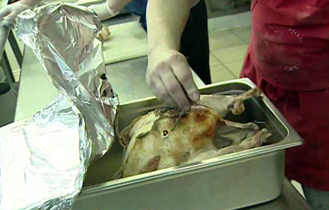 Volunteers prepare turkeys for Thanksgiving dinner.