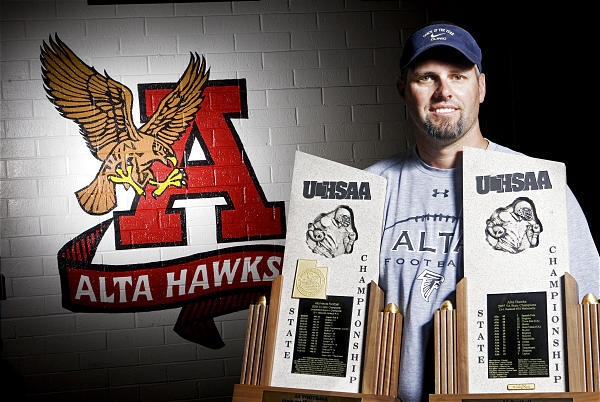 Former Alta head football coach Les Hamilton holding 2 state championship trophies. (Keith Johnson, Deseret News)