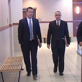 Marc Mathis (left) of the District Attorney's office entering court