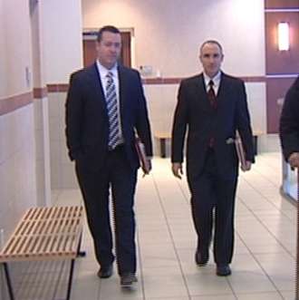 Marc Mathis (left) of the District Attorney's office entering court