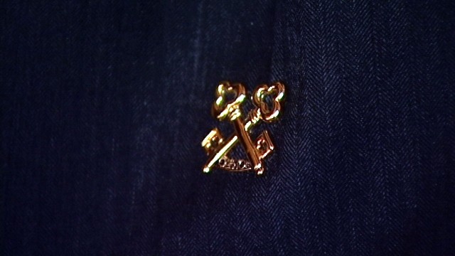 The telltale sign of Les Clef d'Or society membership: the gold key pins.