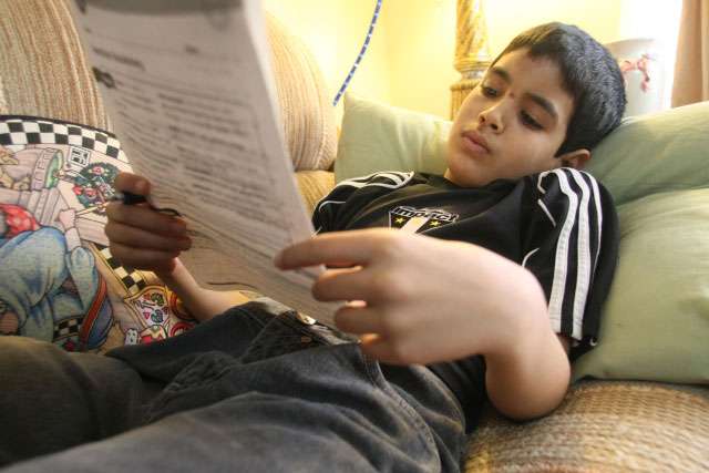 Ahmed Ahmed, 11, does homework at home in Murray on Wednesday, Jan. 19, 2011. The scabs on his face are a result of falling on pavement while playing the pass-out game at school. At least four students were suspended from school for playing the game.
(Kristin Murphy, Deseret News)